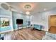 Elegant living room features wood floors, a blue sofa, and a decorative chandelier at 19300 Lonesome Pine Dr, Land O Lakes, FL 34638