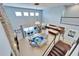 Bright, spacious living room with a soaring ceiling, stone fireplace, and access to a covered patio at 19300 Lonesome Pine Dr, Land O Lakes, FL 34638