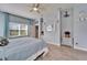 A well-lit main bedroom featuring a large window, a bed, and elegant decor at 19300 Lonesome Pine Dr, Land O Lakes, FL 34638