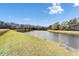 Scenic view of a serene pond surrounded by lush greenery and mature trees on a sunny day at 19300 Lonesome Pine Dr, Land O Lakes, FL 34638