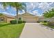 Single-Gathering home with attached garage and manicured lawn at 16903 Peaceful Valley Dr, Wimauma, FL 33598