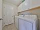 Laundry room with washer, dryer, and cabinets at 16903 Peaceful Valley Dr, Wimauma, FL 33598