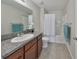 Bathroom with tub, shower, granite countertop, and tile flooring at 16903 Peaceful Valley Dr, Wimauma, FL 33598