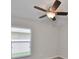 Simple bedroom with ceiling fan and window at 16903 Peaceful Valley Dr, Wimauma, FL 33598