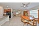 Bright dining room with wood table and view of the living room at 16903 Peaceful Valley Dr, Wimauma, FL 33598