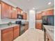 Spacious kitchen featuring wood cabinets and granite countertops at 16903 Peaceful Valley Dr, Wimauma, FL 33598