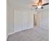 Bedroom with double door closet and ceiling fan at 16903 Peaceful Valley Dr, Wimauma, FL 33598
