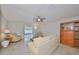 Relaxing living room featuring light colored sofa and wood cabinet at 16903 Peaceful Valley Dr, Wimauma, FL 33598