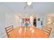 Dining area features wood table and chairs, open to kitchen at 16903 Peaceful Valley Dr, Wimauma, FL 33598