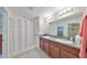 Bathroom boasts double vanity and a shower stall at 16903 Peaceful Valley Dr, Wimauma, FL 33598
