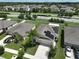 Aerial view of a house with solar panels and a neighborhood at 16903 Peaceful Valley Dr, Wimauma, FL 33598