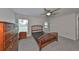 Bright bedroom featuring a ceiling fan and wood bed frame at 16903 Peaceful Valley Dr, Wimauma, FL 33598