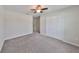 Bedroom with ceiling fan, closet, and carpet flooring at 16903 Peaceful Valley Dr, Wimauma, FL 33598