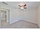 Bedroom with ceiling fan, carpet flooring, and en-suite bathroom at 16903 Peaceful Valley Dr, Wimauma, FL 33598