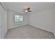 Bedroom with window, ceiling fan, and carpet flooring at 16903 Peaceful Valley Dr, Wimauma, FL 33598