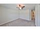 Spacious bedroom with ceiling fan and carpet flooring at 16903 Peaceful Valley Dr, Wimauma, FL 33598