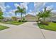 Well-maintained house with a driveway and attractive landscaping at 16903 Peaceful Valley Dr, Wimauma, FL 33598