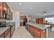 Open concept kitchen with island and granite countertops at 16903 Peaceful Valley Dr, Wimauma, FL 33598
