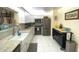 Modern kitchen with stainless steel appliances and granite countertops at 100 Bluff View Dr # 605A, Belleair Bluffs, FL 33770