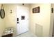 Bright condo entryway with tile floors and decorative wall art at 100 Bluff View Dr # 605A, Belleair Bluffs, FL 33770