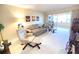 Living room with comfy seating, large windows and access to balcony at 100 Bluff View Dr # 605A, Belleair Bluffs, FL 33770
