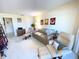 Living room with light colored couch and two armchairs, artwork, and carpet at 100 Bluff View Dr # 605A, Belleair Bluffs, FL 33770