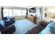 Spacious living room with leather furniture and large windows at 100 Bluff View Dr # 605A, Belleair Bluffs, FL 33770