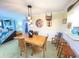 Bright dining room featuring a wood table and unique wall decor at 100 Bluff View Dr # 605A, Belleair Bluffs, FL 33770