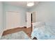 Bedroom with white closet doors and wood-look tile floor at 19300 Lonesome Pine Dr, Land O Lakes, FL 34638