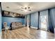 Spacious bonus room features a ceiling fan, wood-look tile flooring, and plenty of natural light at 19300 Lonesome Pine Dr, Land O Lakes, FL 34638