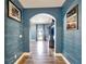 Elegant hallway with arched entryway leading to the living room at 19300 Lonesome Pine Dr, Land O Lakes, FL 34638