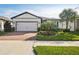 Attractive single-story home with a white garage door and landscaping at 18933 Sailors Delight Pass, Land O Lakes, FL 34638