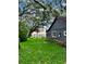 Large backyard with grassy lawn and mature oak trees at 800 Stubbs St, Brooksville, FL 34601