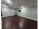 Simple bedroom with dark hardwood floors and neutral walls at 800 Stubbs St, Brooksville, FL 34601