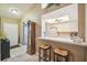 Kitchen with breakfast bar and view into living room at 4137 Edgewood Dr, Holiday, FL 34691