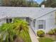 Well-maintained exterior featuring a charming walkway and lush landscaping at 4137 Edgewood Dr, Holiday, FL 34691