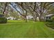 Landscaped community grounds with mature trees and walking paths at 4137 Edgewood Dr, Holiday, FL 34691