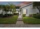 Front view of charming villa with walkway and well-manicured lawn at 4137 Edgewood Dr, Holiday, FL 34691