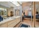 Main bathroom with double sinks and view into bedroom at 4137 Edgewood Dr, Holiday, FL 34691