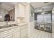 Galley style kitchen with white cabinets and view of dining area at 4137 Edgewood Dr, Holiday, FL 34691