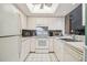 Efficient kitchen with white cabinetry, ample counter space, and appliances at 4137 Edgewood Dr, Holiday, FL 34691