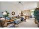 Bright living room featuring a sectional sofa and large windows at 4137 Edgewood Dr, Holiday, FL 34691