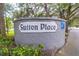 Stone community sign for Sutton Place surrounded by lush greenery, offering a sense of established neighborhood charm at 1722 Castle Rock Rd, Tampa, FL 33612