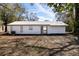 The backyard features a sliding glass door and windows in the home's back exterior at 3432 Danny Bryan Blvd, Tampa, FL 33619