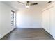 Neutral bedroom featuring laminate flooring, a ceiling fan, closet, and a large window at 3432 Danny Bryan Blvd, Tampa, FL 33619