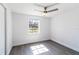 Bright bedroom with a ceiling fan, new floors, neutral walls, and a large window at 3432 Danny Bryan Blvd, Tampa, FL 33619