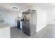 Modern kitchen featuring stainless steel appliances, granite countertops, and white cabinets at 3432 Danny Bryan Blvd, Tampa, FL 33619