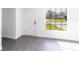 A bright and airy living room with modern gray laminate flooring and a new front door at 3432 Danny Bryan Blvd, Tampa, FL 33619