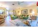 Cozy living room with green sofas and a comfortable seating area at 16252 Amethyst Key Dr, Wimauma, FL 33598