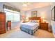 Relaxing bedroom with a comfortable bed and wood furniture at 16252 Amethyst Key Dr, Wimauma, FL 33598